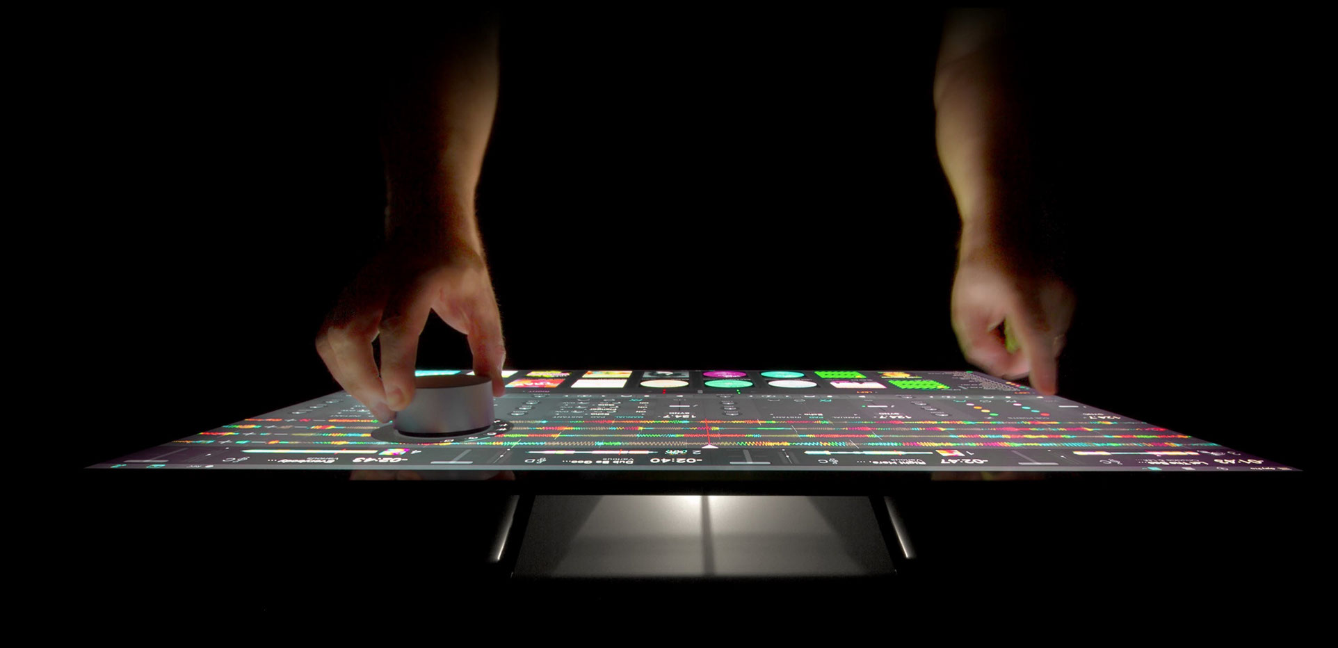 Hands using a Microsoft Surface Studio touchscreen with the Surface Dial